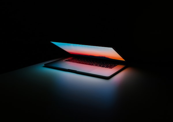 Designer working on laptop with 2D tools